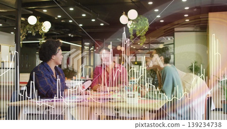 Five professionals collaborating on printed charts at table in office, with translucent overlay Five professionals collaborating on printed charts at table in office, with translucent overlay 139234738