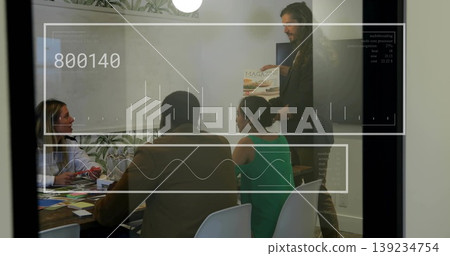 Holding magazine, presenter guiding three colleagues in conference room, with color swatches Holding magazine, presenter guiding three colleagues in conference room, with color swatches 139234754