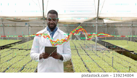 Researcher in lab coat with tablet analyzing data in greenhouse, with seedlings and chart overlay Researcher in lab coat with tablet analyzing data in greenhouse, with seedlings and chart overlay 139234804