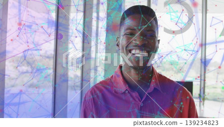 Standing man wearing red shirt exploring network overlay in office, glass panels, steel columns Standing man wearing red shirt exploring network overlay in office, glass panels, steel columns 139234823