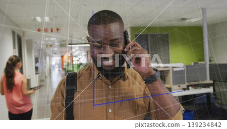 Talking smiling man holding smartphone and carrying backpack in office corridor with AR grid Talking smiling man holding smartphone and carrying backpack in office corridor with AR grid 139234842