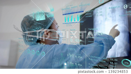 Pointing doctor in scrubs in exam room, using display showing X-ray arm, financial data, copy space Pointing doctor in scrubs in exam room, using display showing X-ray arm, financial data, copy space 139234853