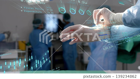Manipulating gloved hand using holographic financial charts in operating theatre, copy space Manipulating gloved hand using holographic financial charts in operating theatre, copy space 139234862