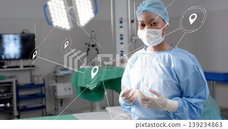 Monitoring surgeon in blue scrubs checking monitor in operating room, with pin icons, copy space Monitoring surgeon in blue scrubs checking monitor in operating room, with pin icons, copy space 139234863