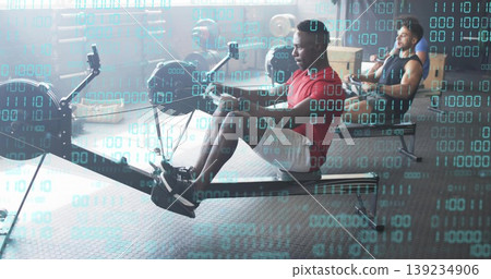 Rowing man in red T-shirt and white shorts on ergometer at gym with binary code overlay Rowing man in red T-shirt and white shorts on ergometer at gym with binary code overlay 139234906