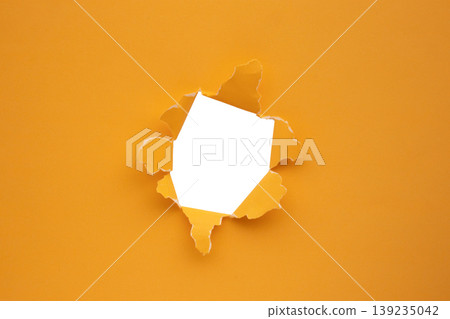 Torn ripped orange paper hole isolated on white background Torn ripped orange paper hole isolated on white background 139235042