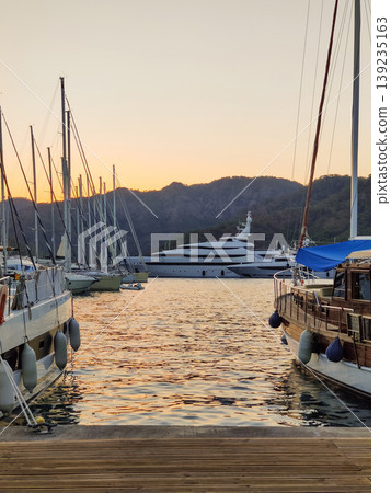 beautiful ships and boats are moored near the shore beautiful ships and boats are moored near the shore 139235163