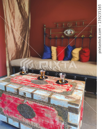 Traditional Turkish tea served on a vintage chest in a cozy interior Traditional Turkish tea served on a vintage chest in a cozy interior 139235165