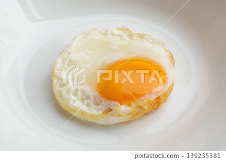 Fried egg on white dish close up Fried egg on white dish close up 139235381