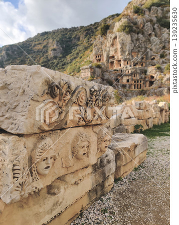 Ancient stone theater masks and Corinthian column capital in Myra Turkey 139235630