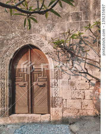 Ancient carved wooden door with intricate patterns in Lindos Rhodes Ancient carved wooden door with intricate patterns in Lindos Rhodes 139235697