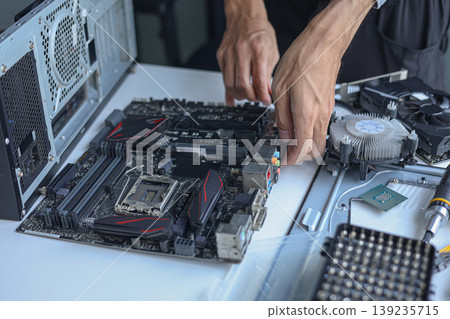 Professional technician or engineer repairing or assembling electronic computer PC equipment. Professional technician or engineer repairing or assembling electronic computer PC equipment. 139235715