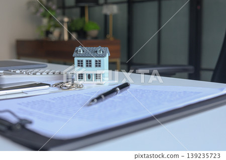 Signing contract for housing. Concept for real estate investment, home buying, selling, insurance, loan, lease, mortgage Signing contract for housing. Concept for real estate investment, home buying, selling, insurance, loan, lease, mortgage 139235723