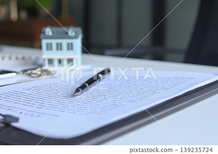 Signing contract for housing. Concept for real estate investment, home buying, selling, insurance, loan, lease, mortgage Signing contract for housing. Concept for real estate investment, home buying, selling, insurance, loan, lease, mortgage 139235724