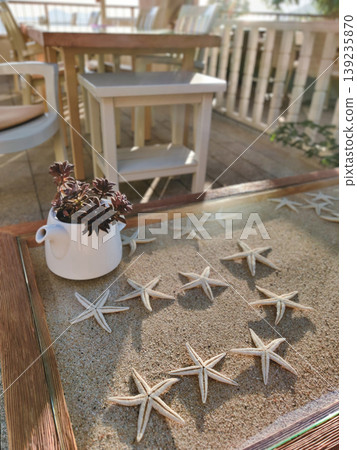 Decorative table with starfish and sand in a Kalkan beach cafe Decorative table with starfish and sand in a Kalkan beach cafe 139235870