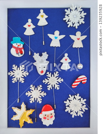Set of Christmas and winter themed pins and brooches on blue background Set of Christmas and winter themed pins and brooches on blue background 139235928
