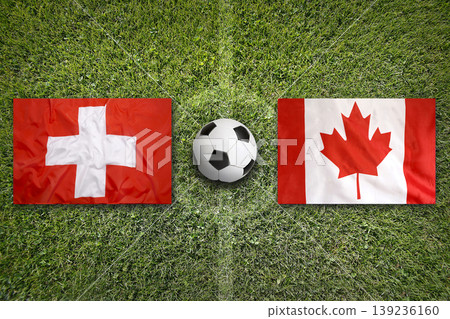 Switzerland vs. Canada flags on a soccer field Switzerland vs. Canada flags on a soccer field 139236160