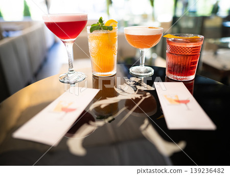 beautiful and delicious alcoholic cocktails prepared at the bar by the bartender. 139236482