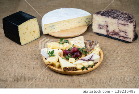 Artisanal cheese assortment with a platter and large gourmet wheels Artisanal cheese assortment with a platter and large gourmet wheels 139236492