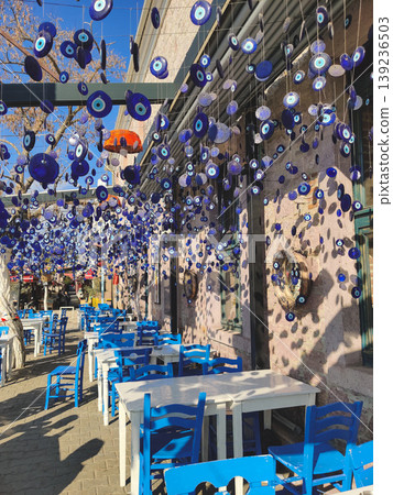 Outdoor cafe terrace decorated with hanging evil eye Nazar charms Outdoor cafe terrace decorated with hanging evil eye Nazar charms 139236503