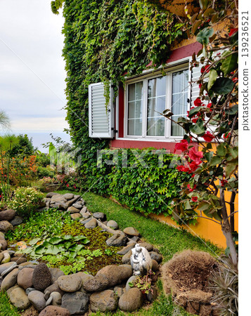 Beautiful and colorful facade of the house with many flowers and plants Beautiful and colorful facade of the house with many flowers and plants 139236521