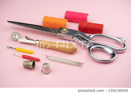 various tailor accessories and tools for tailoring on a pink background various tailor accessories and tools for tailoring on a pink background 139236609