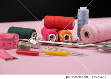 various tailor accessories and tools for tailoring on a pink background various tailor accessories and tools for tailoring on a pink background 139236610