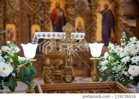 Golden altar cross with rays and floral background 139236616