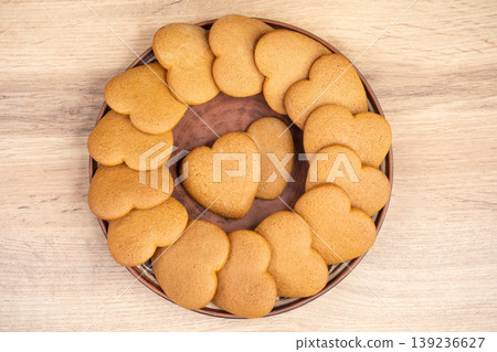 Heart-shaped ginger cookies arranged on a ceramic plate 139236627