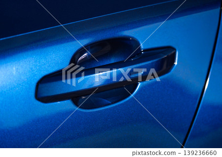 Close-up of a car door handle on a dark blue metallic sedan Close-up of a car door handle on a dark blue metallic sedan 139236660