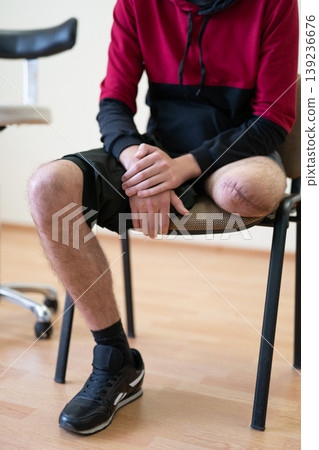 Ukrainian soldier with an amputated leg sitting in a rehabilitation clinic 139236676