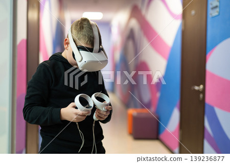 a child in virtual reality glasses plays a game a child in virtual reality glasses plays a game 139236877