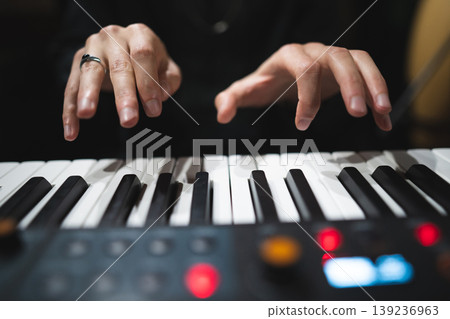 close-up of a pianist's hands while playing the piano close-up of a pianist's hands while playing the piano 139236963