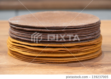 Stack of thin chocolate and plain honey cake layers Stack of thin chocolate and plain honey cake layers 139237005