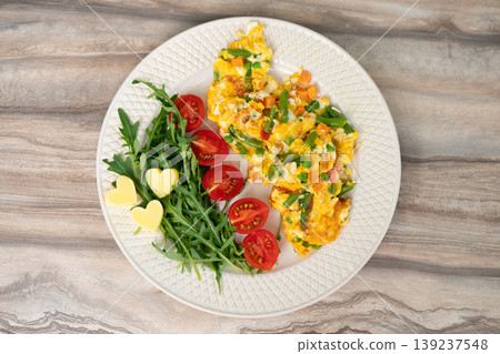 Scrambled eggs with vegetables served with arugula and cherry tomatoes Scrambled eggs with vegetables served with arugula and cherry tomatoes 139237548