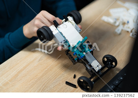 Student assembling a programmable robot car Student assembling a programmable robot car 139237562