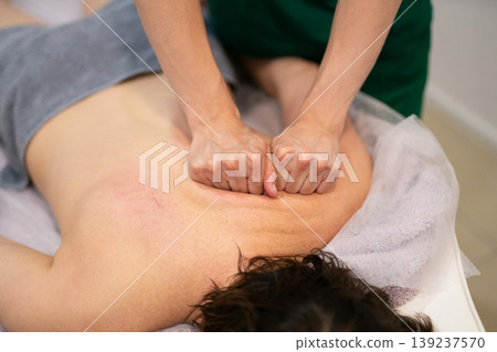 Professional back massage treatment in a spa or medical clinic Professional back massage treatment in a spa or medical clinic 139237570
