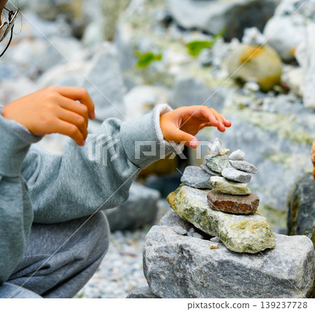 Relaxed spiritually child's hand arrangement pebble tower. Yoga relax meditation Relaxed spiritually child's hand arrangement pebble tower. Yoga relax meditation 139237728