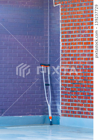 Crutches isolated on wall background. Old Crutches on the wall Crutches isolated on wall background. Old Crutches on the wall 139237729