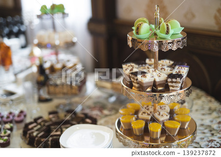 Delicious sweet cakes and desserts at the festive candy bar Delicious sweet cakes and desserts at the festive candy bar 139237872