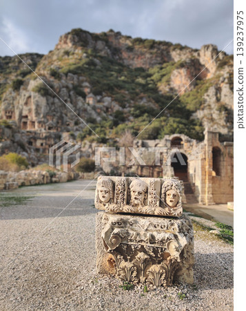 Ancient stone theater masks and Corinthian column capital in Myra Turkey 139237975