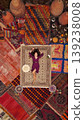 a beautiful girl in dress in a traditional turkish interior with many carpets on the wall 139238008