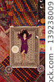 a beautiful girl in dress in a traditional turkish interior with many carpets on the wall 139238009