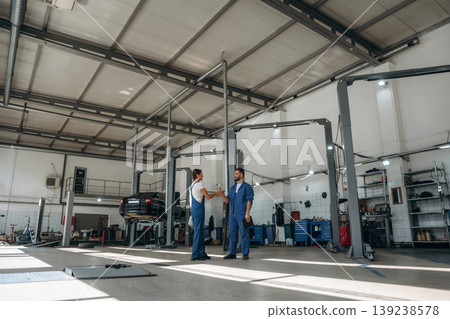 Auto repair shop employees are working together. Man and woman Auto repair shop employees are working together. Man and woman 139238578