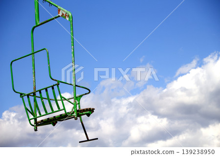 Empty Ski Lift Chair Against Blue Sky 139238950