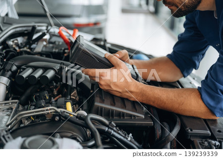 Electronics testing, checking. Male mechanic is working in the modern car workshop Electronics testing, checking. Male mechanic is working in the modern car workshop 139239339