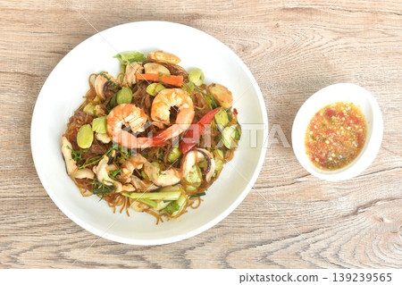 stir-fried glass noodles with three stinky vegetables and shrimp couple squid on plate dipping spicy chili sauce 139239565