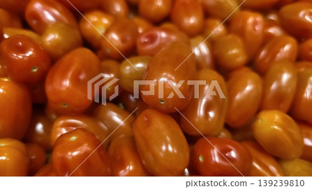 Close-up of glossy red grape tomatoes in a pile Close-up of glossy red grape tomatoes in a pile 139239810
