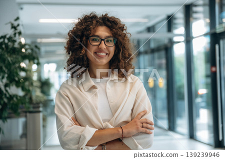 Pretty woman in casual clothes is in the modern building indoors Pretty woman in casual clothes is in the modern building indoors 139239946