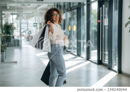 Smiling, feeling good. Woman is with shopping bags indoors in the supermarket Smiling, feeling good. Woman is with shopping bags indoors in the supermarket 139240044